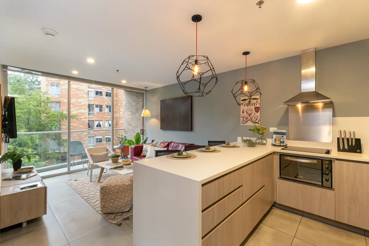 Kitchen and living area of the apartment for sale at Soul Lifestyle, Medellín