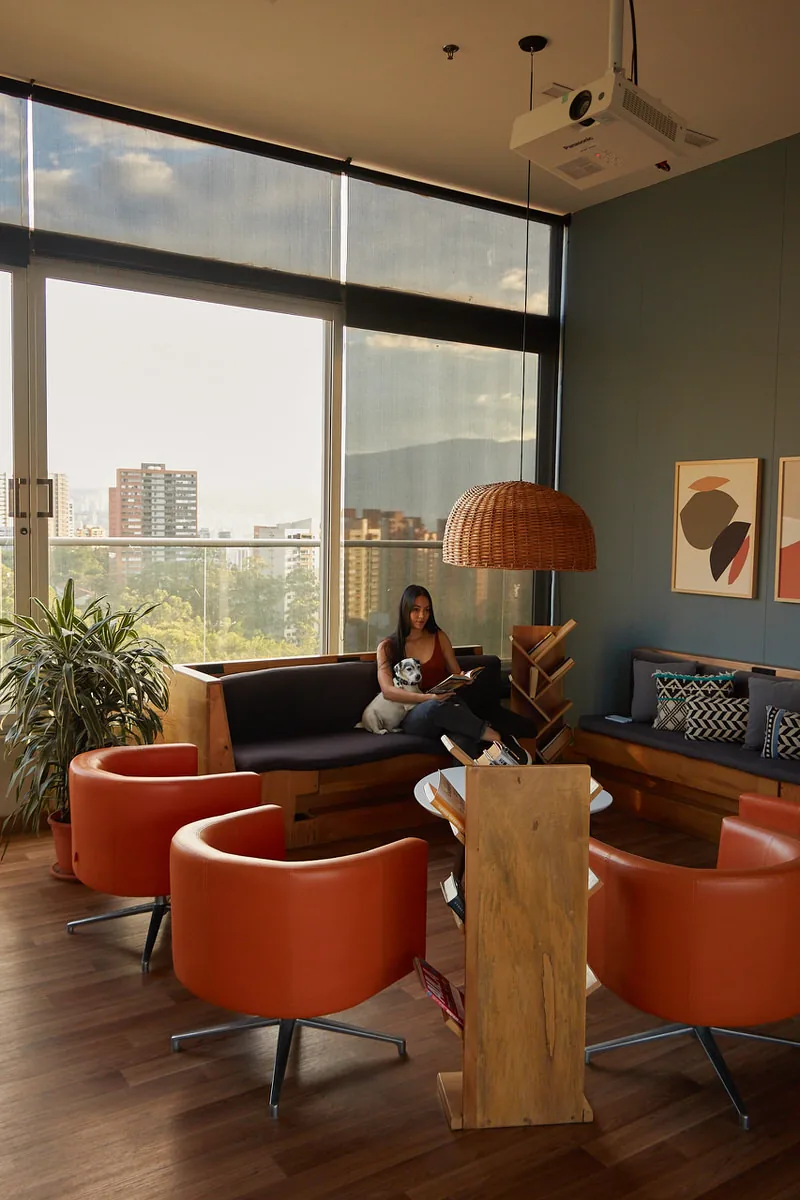 Lounge with orange chairs at Soul Lifestyle Apartments, El Poblado