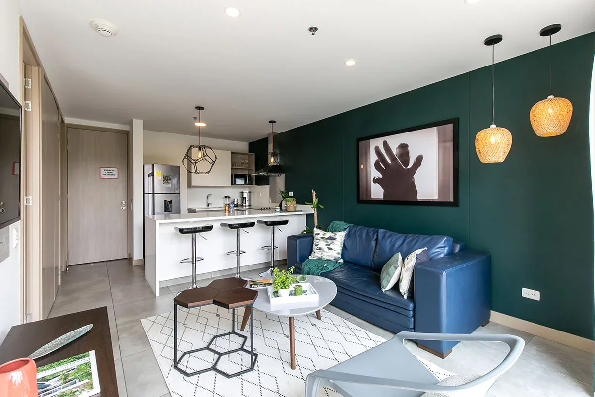 Living room with green accents in a Classic apartment at Soul Lifestyle Apartments