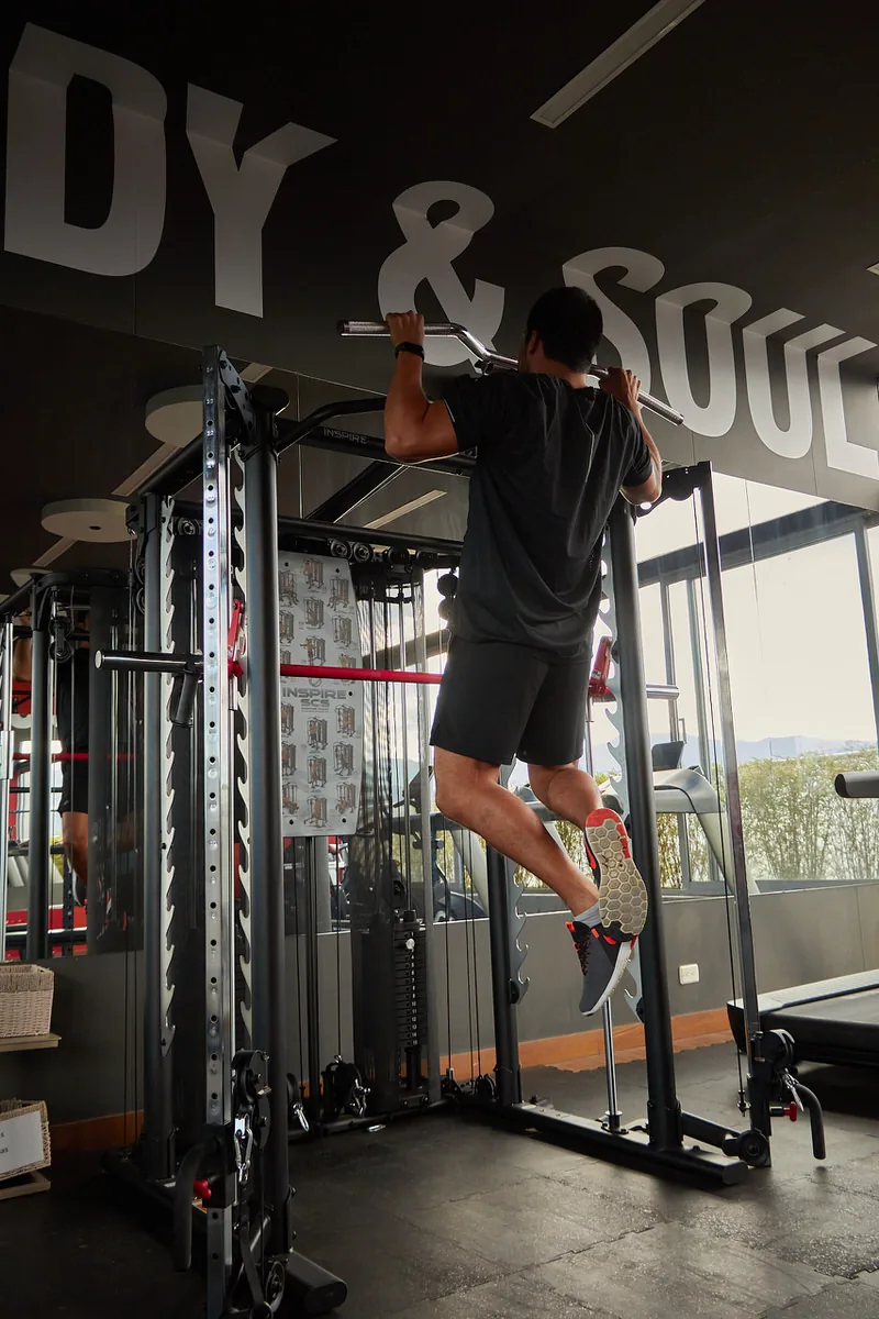 Guest doing pull-ups in the rooftop gym at Soul Lifestyle Apartments