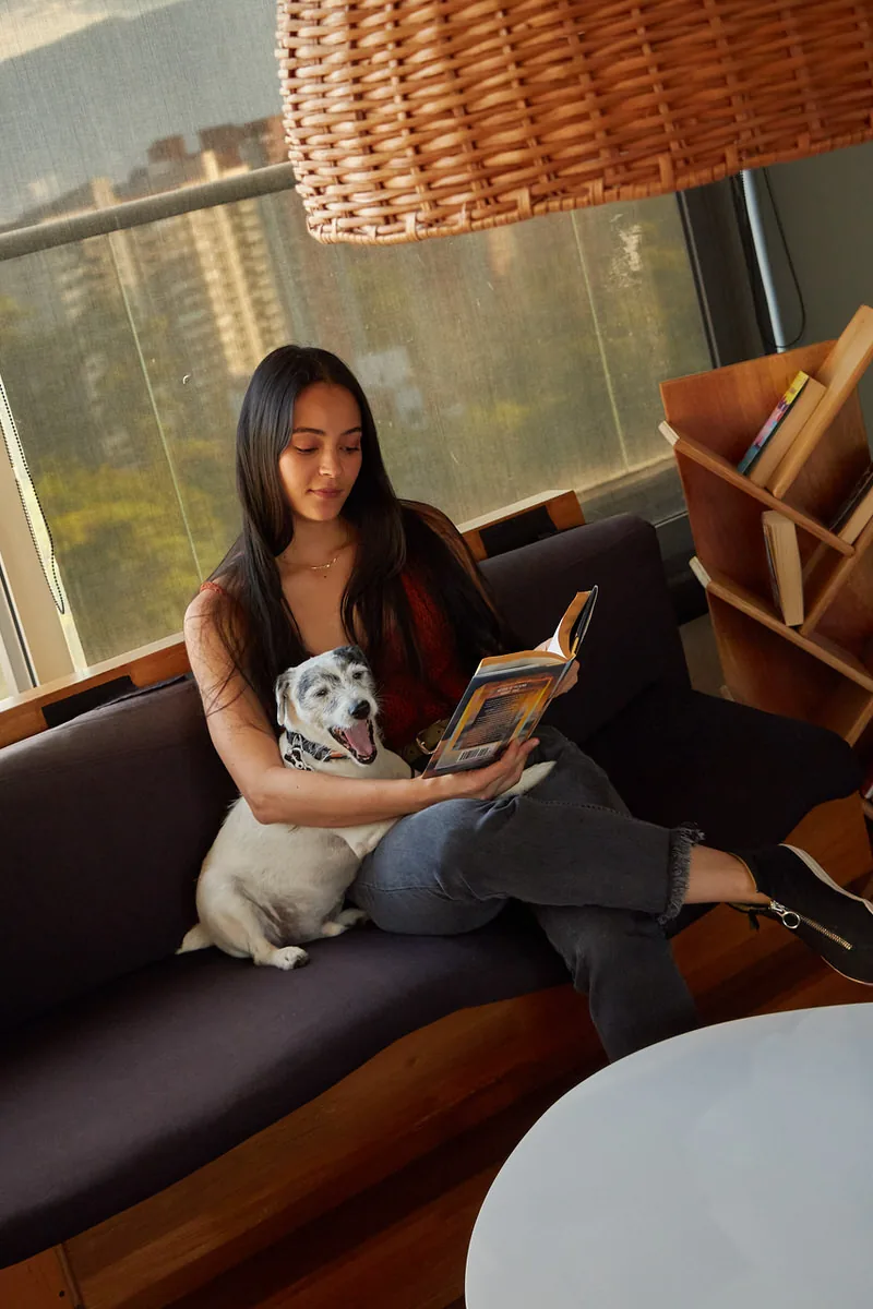 Guest reading with her dog at the pet friendly Soul Lifestyle Apartments