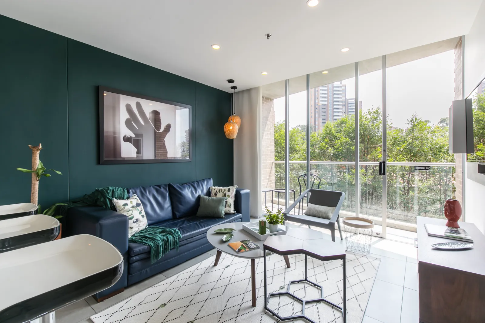 Living room with sofa and balcony doors in the apartment for sale at Soul Lifestyle