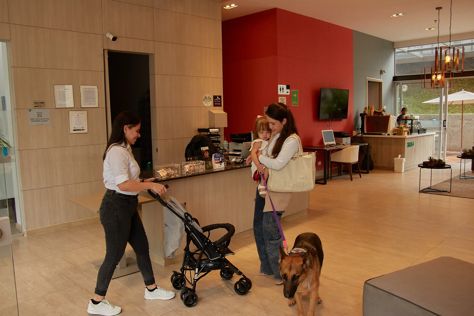 Family with stroller and dog in the lobby of Soul Lifestyle Apartments