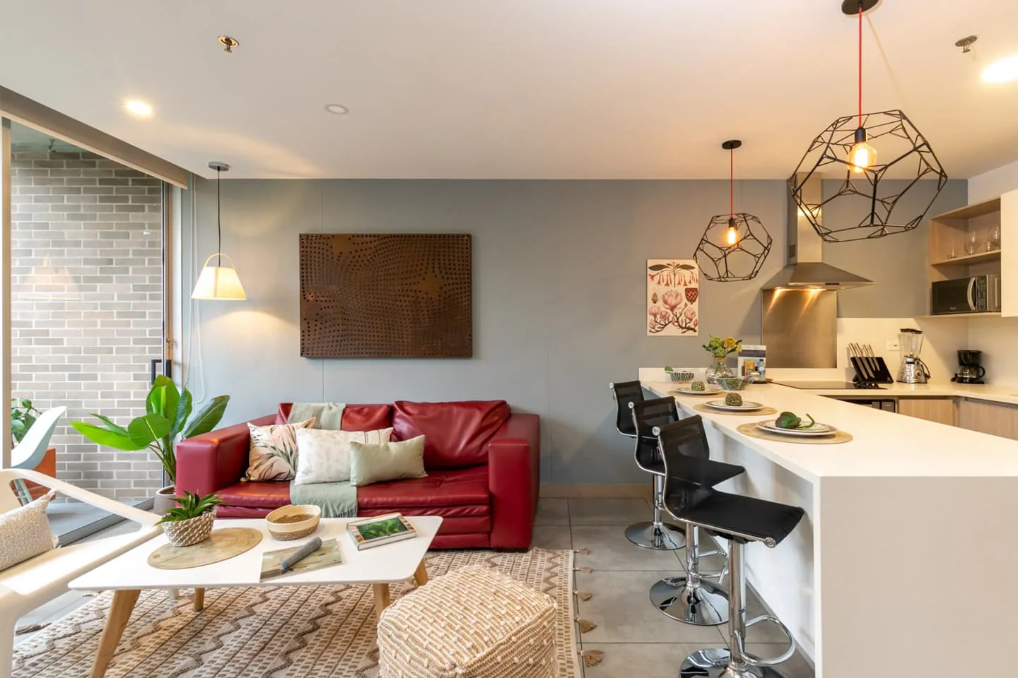 Living room with red sofa in the condo-hotel apartment for sale at Soul Lifestyle
