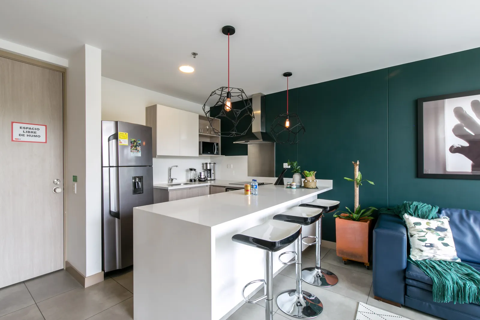 Kitchen island with bar stools in the apartment for sale at Soul Lifestyle Apartments