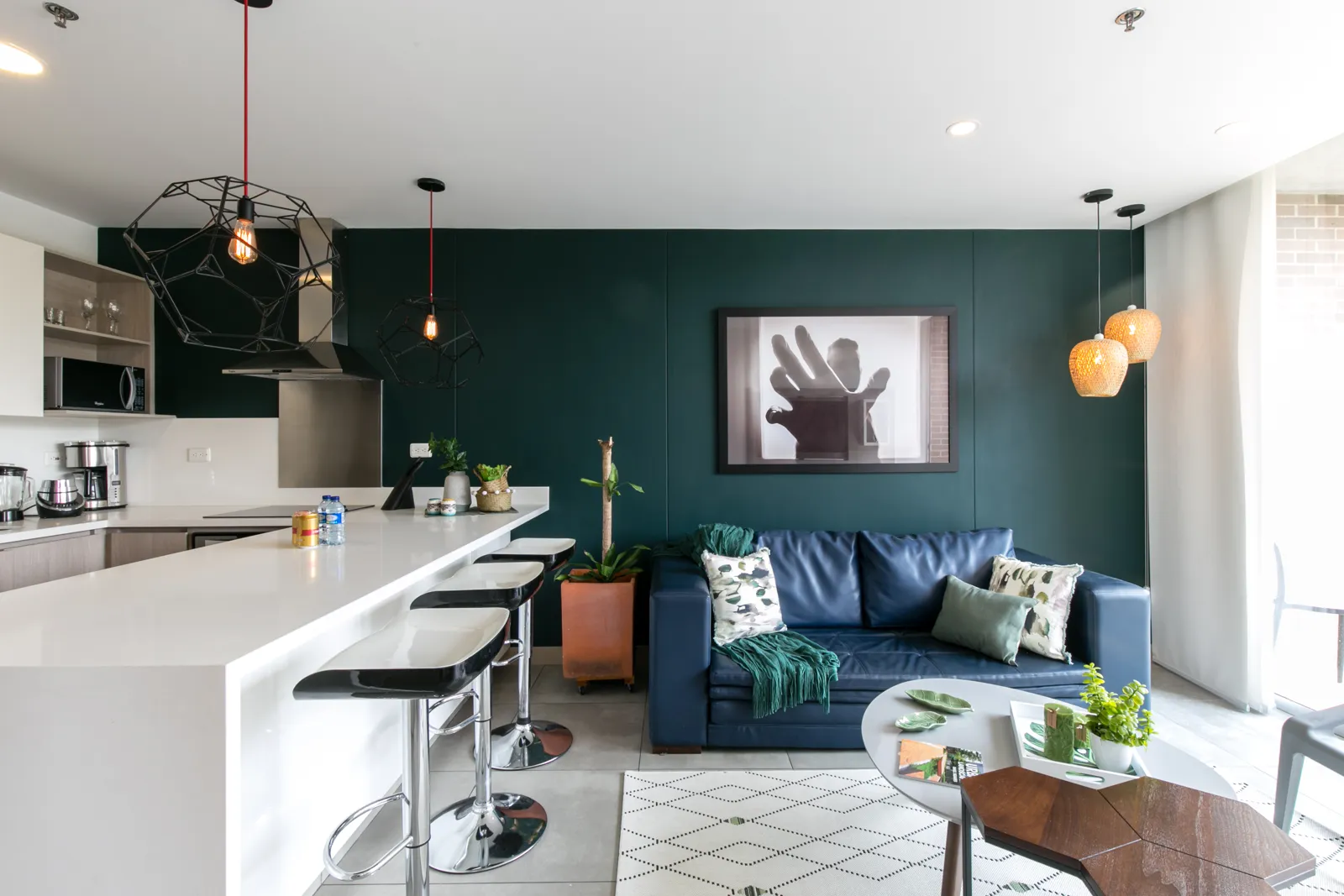 Kitchen island and living area of the apartment for sale at Soul Lifestyle, El Poblado